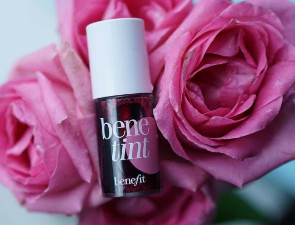 Benefit benetint lip tint bottle surrounded by pink roses