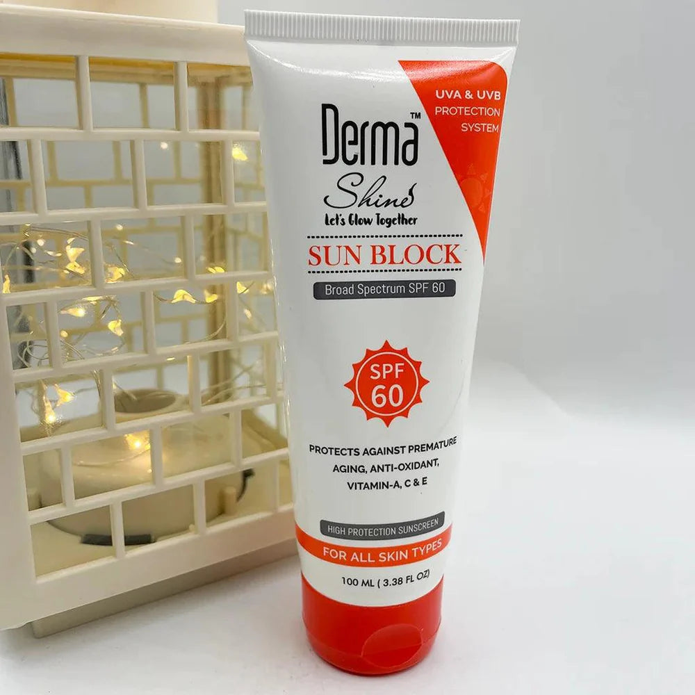Tube of Derma Shine sun block cream on a white surface with a decorative basket in the background.