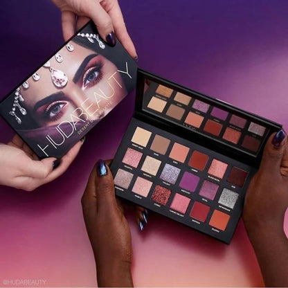 Makeup palette with Huda Beauty packaging on a gradient purple and pink background