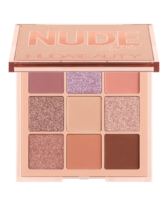 Makeup palette with 'NUDE' and 'HUDA BEAUTY' branding on a white background