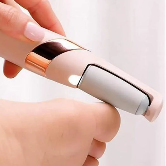 Hand holding a small electronic device with a rose gold and silver design on a white background