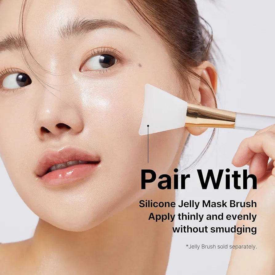 Woman applying silicone jelly mask brush to her face with text on a white background